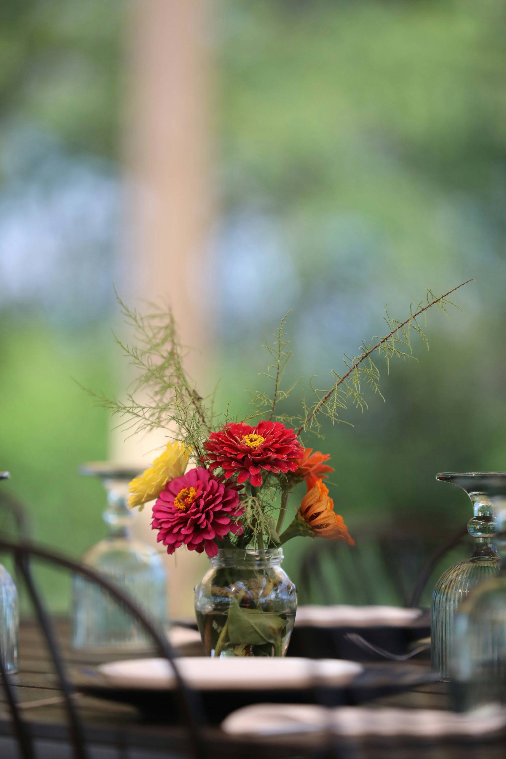 A small vase of colourful flowers decorating a laid table at a wake gathering, reflecting the personal and thoughtful touches that make every send-off unique.